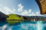 Blick auf klaren See und grüne Hügel unter blauem Himmel