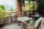 Balkon mit Holzmöbeln und Blick auf die Landschaft