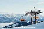 Skilift mit Bergkulisse in verschneiter Landschaft