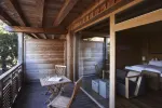 Holzbalkon mit Stühlen und Innensicht